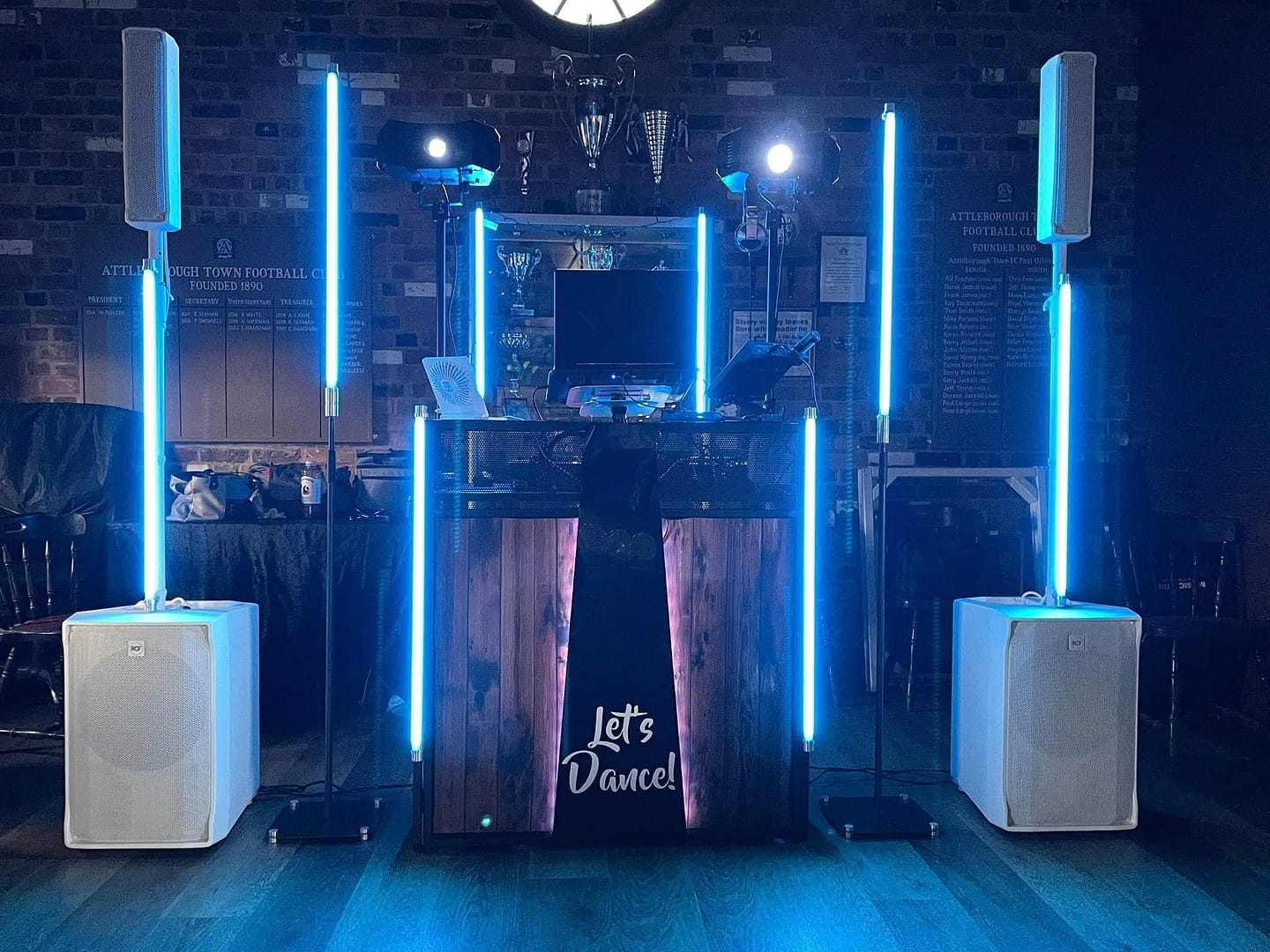 Professional DJ lighting setup with colorful LED lights illuminating a dancefloor